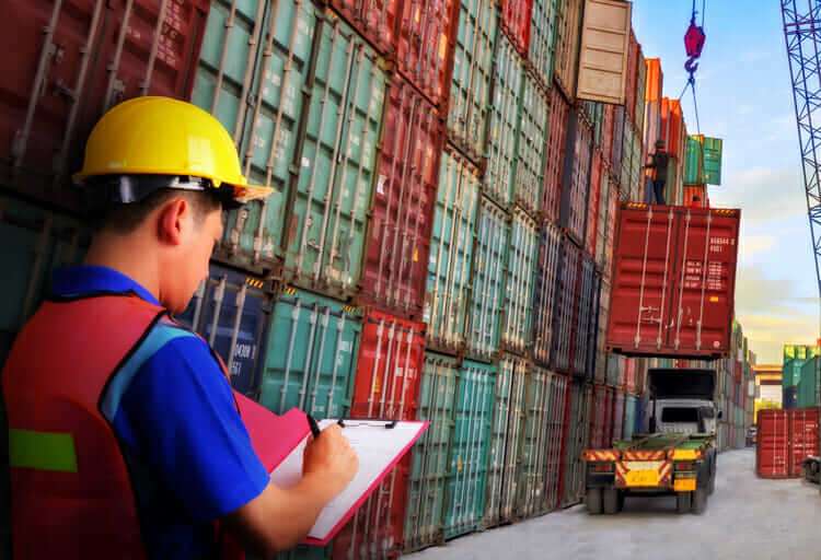 A picture of a person preparing to ship a package, with boxes and shipping materials in the background. This could represent the importance of properly planning and preparing for the shipping and customs process when importing from China.