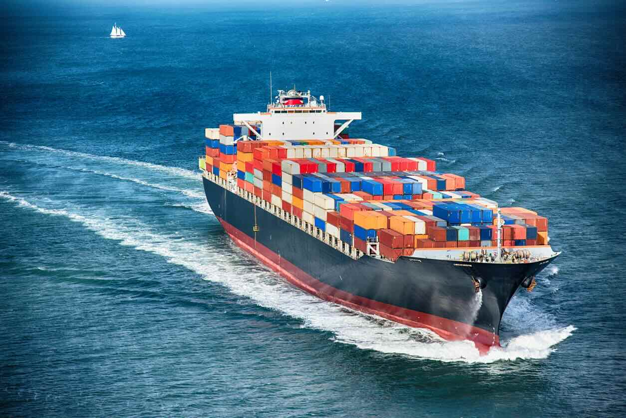 A large cargo container ship out to sea.