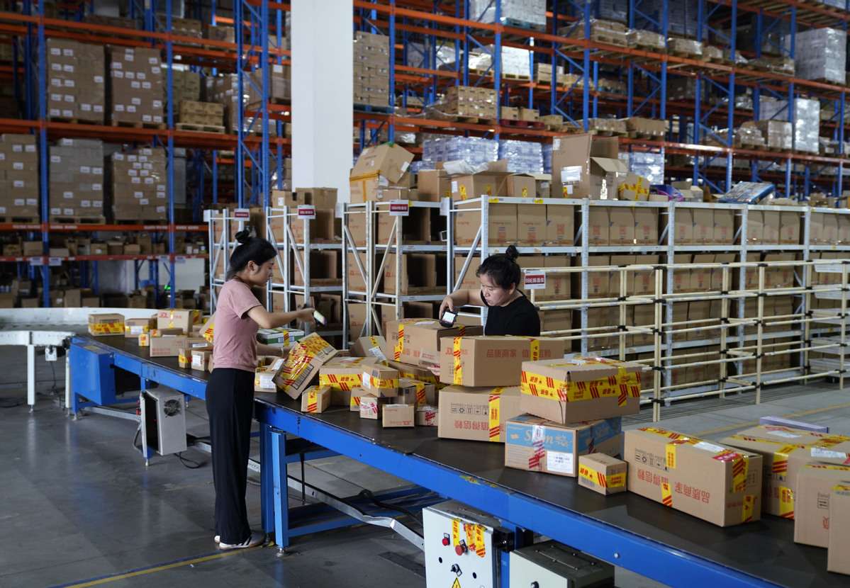 Fulfillment center with packages being prepared for shipping.